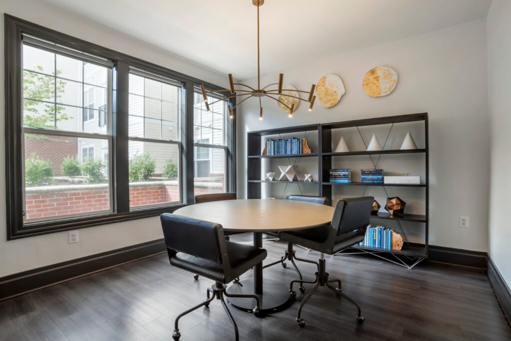 A conference room with room for 4 people at a table.