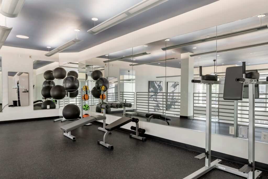 A corner of the upper gym with benches and medicine balls