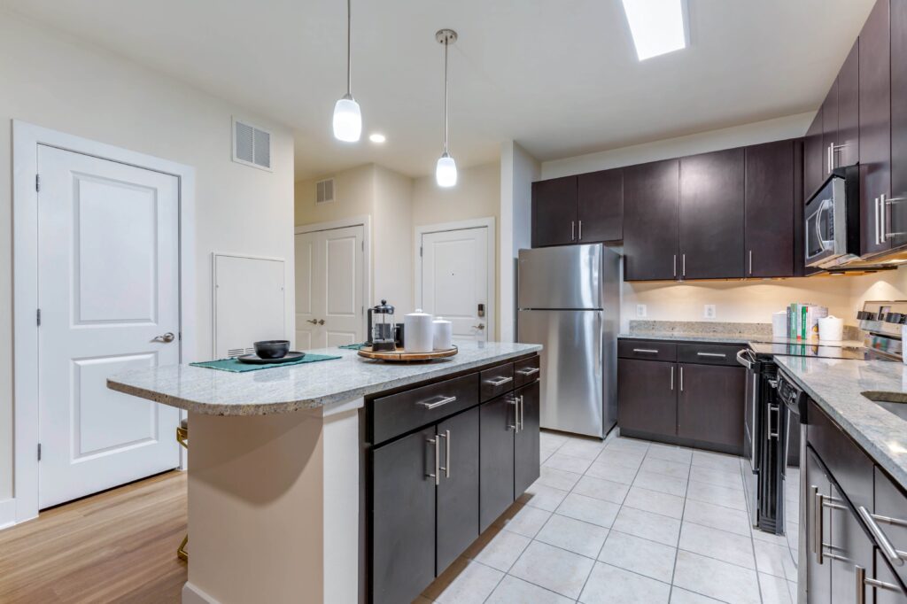 Kitchen with plenty of counter space and an eat-at island. Stainless steel appliances , tile floors.